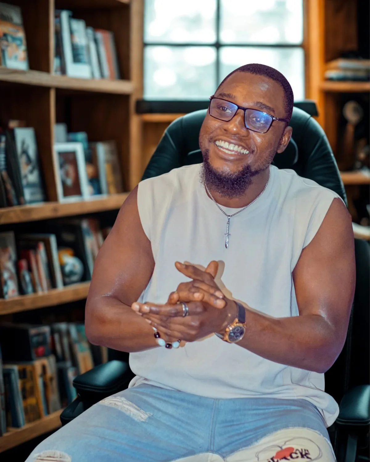 Levi Henry smiling, seated in his study